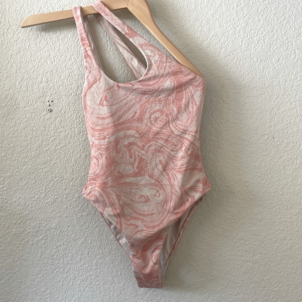L Space asymmetrical one piece swimsuit. Shimmery Peach Swirl Pattern